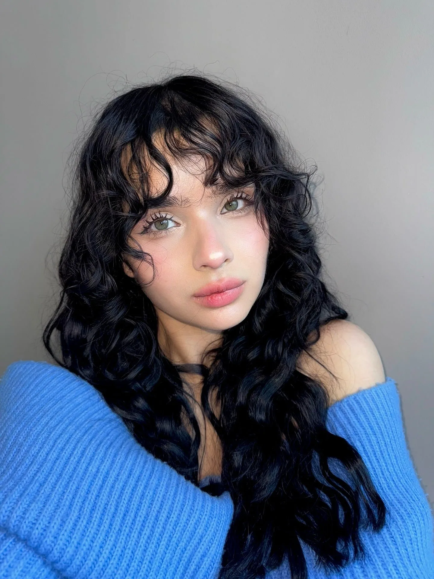 10. Long Jet Black Waves with Wispy Bangs (Messy Curly Hair)