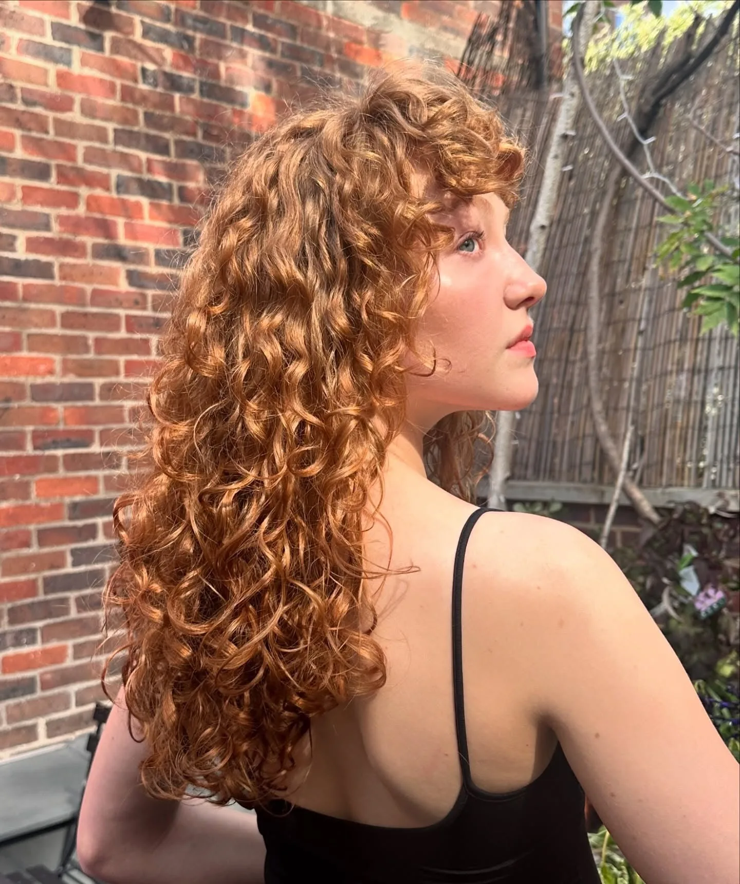 11. Copper Curly Layers with Fringe (Messy Curly Hair)