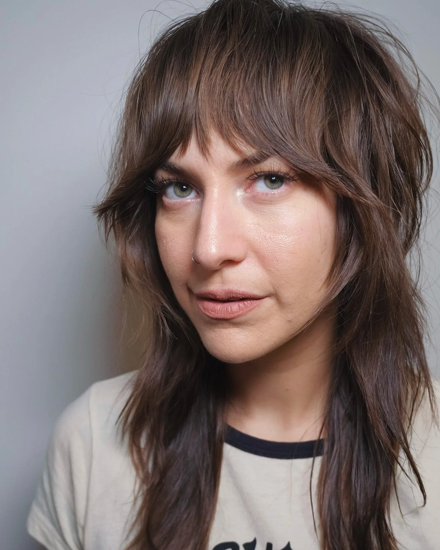 2. Chocolate Feathered Shag with Curtain Bangs (Medium Layered Shag)