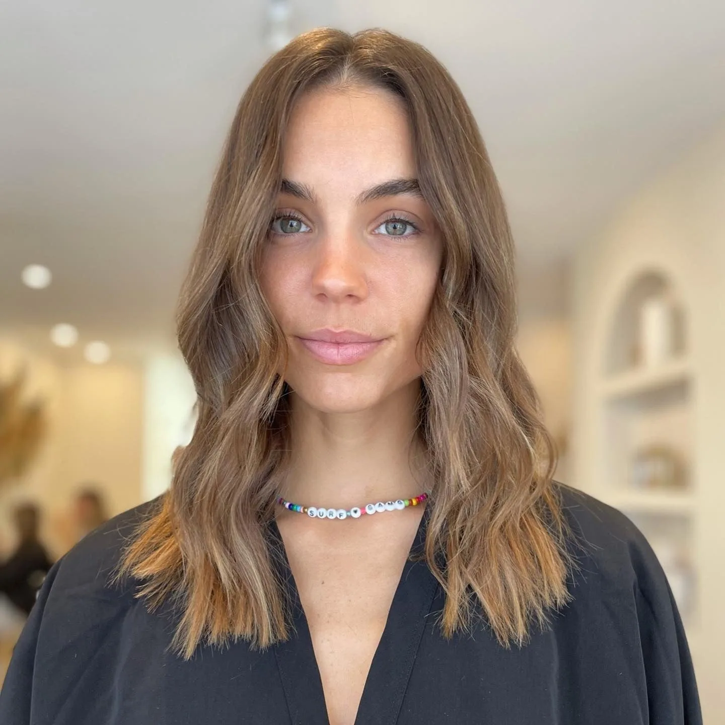 8. Glossy Chestnut Waves with Middle Part (Tousled Hairstyles)