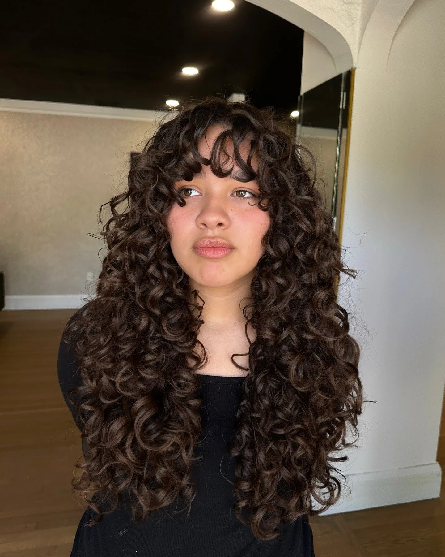 1. Defined Cascade with Wispy Fringe (Wispy Bangs For Curly Hair)