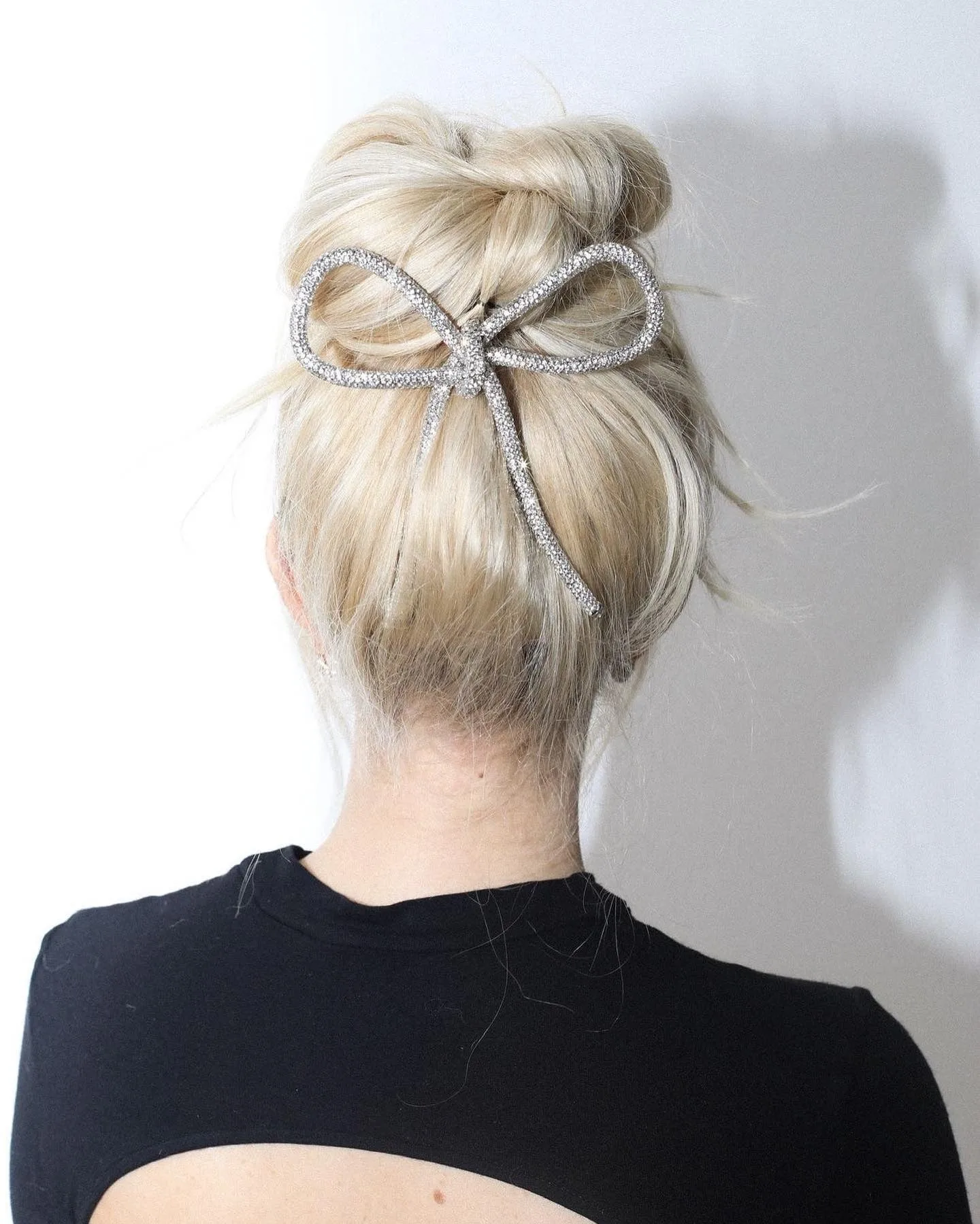 11. Icy Blonde Twisted Top Knot with Crystal Bow Accent (Top Knot Hairstyles)