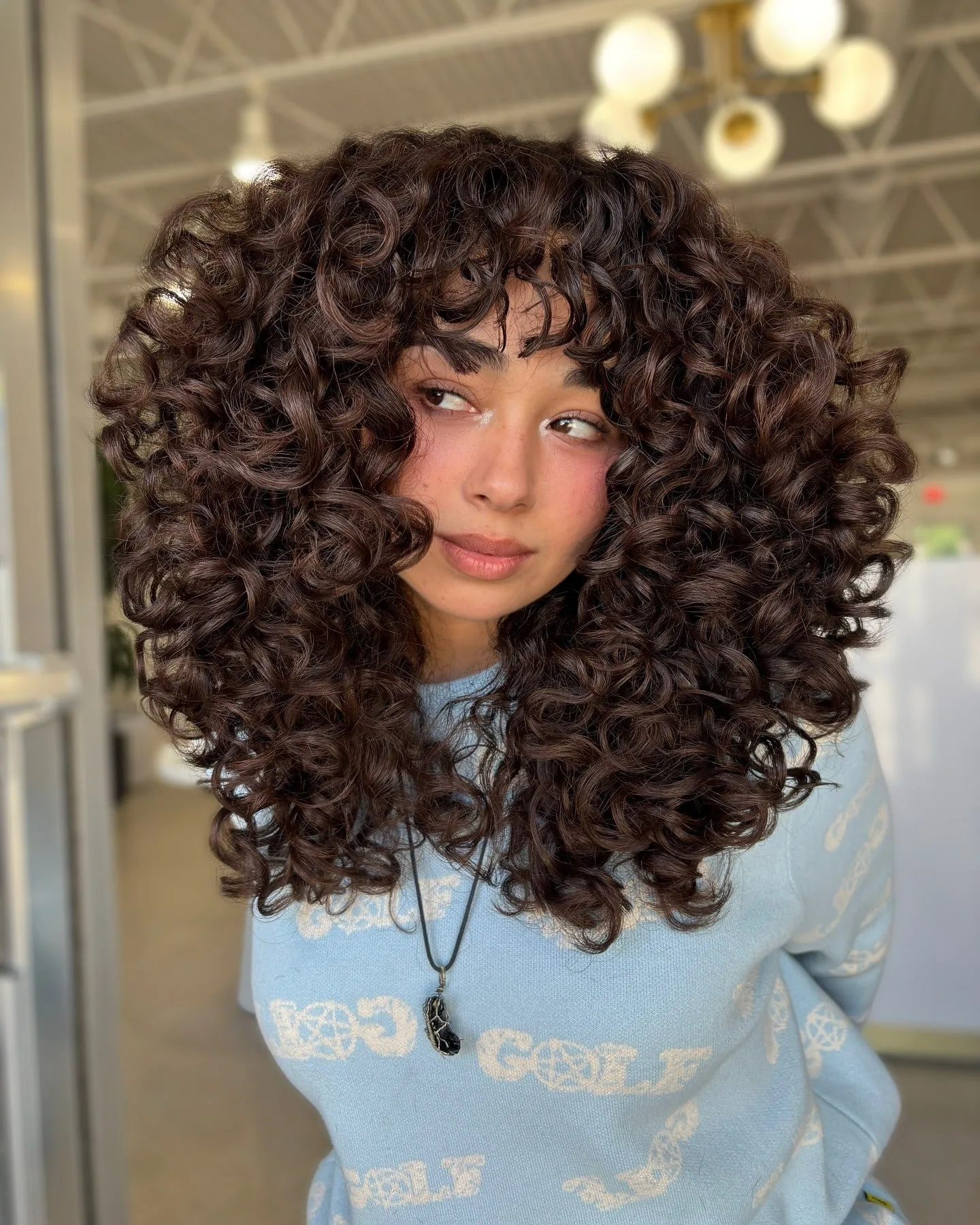 11. Voluminous Halo with Airy Wispy Bangs (Wispy Bangs For Curly Hair)