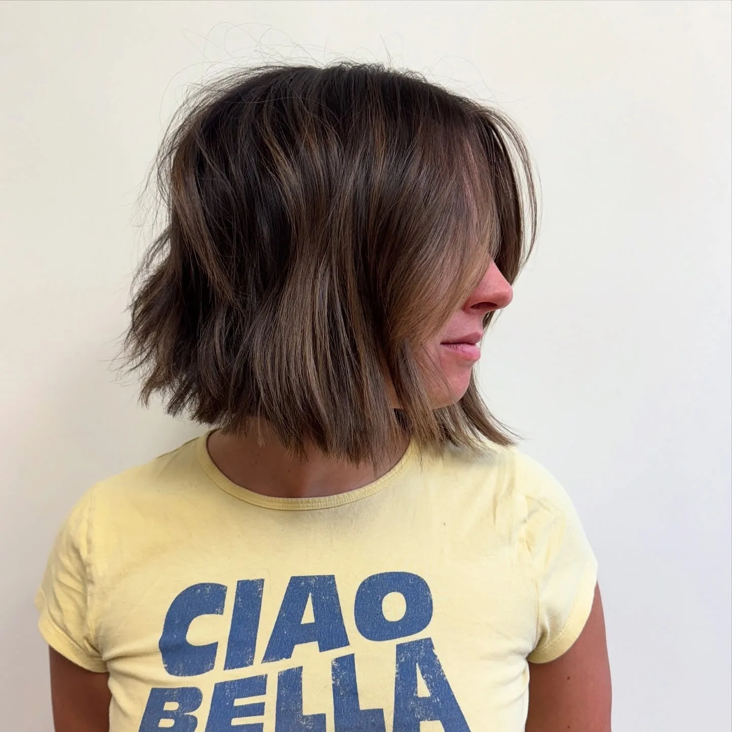 2. Chocolate Brunette Bob with Feathered Ends (Messy Bob Haircut)