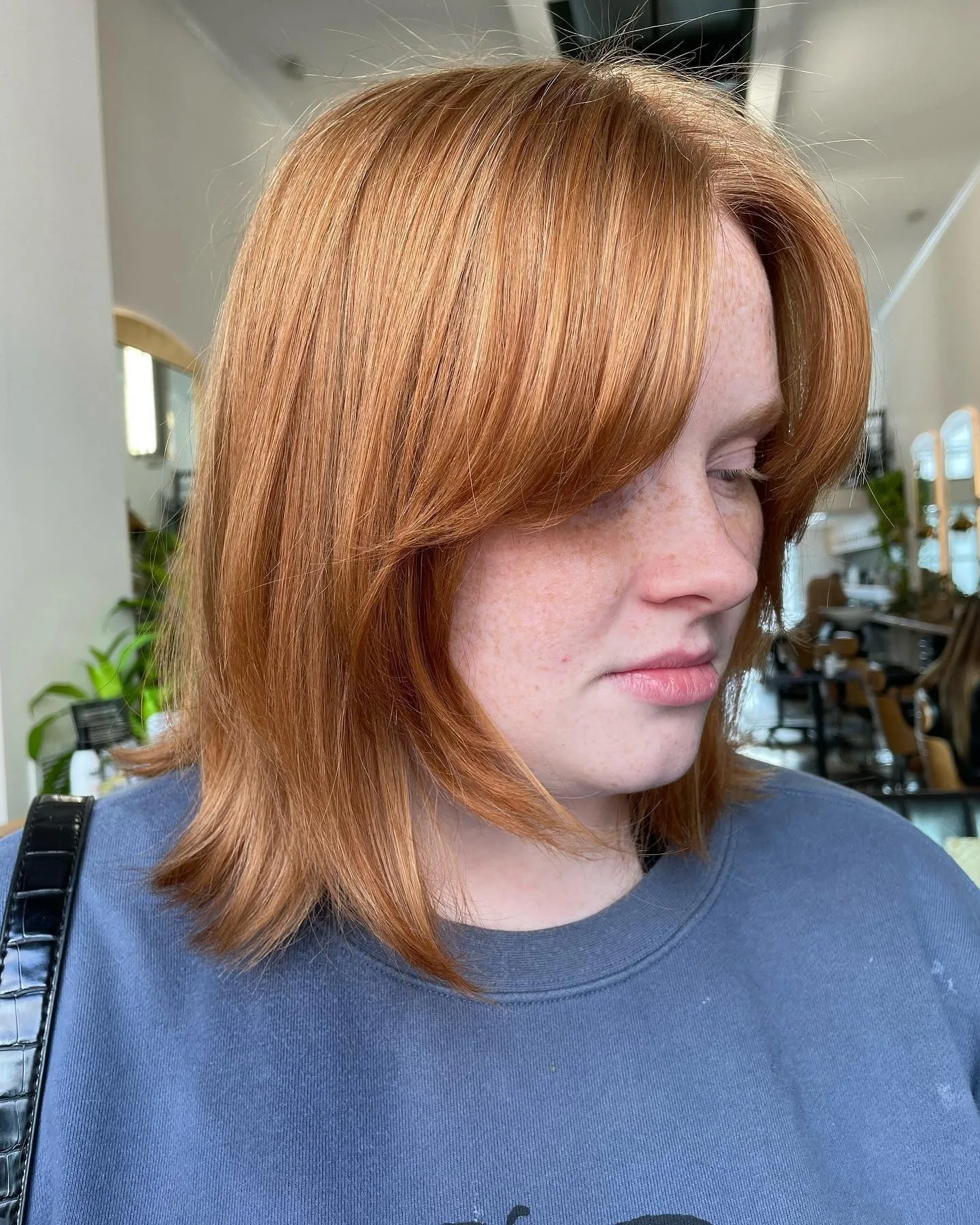 2. Sleek Copper Layered Bob with Curtain Bangs (Shaggy Bob Haircuts)