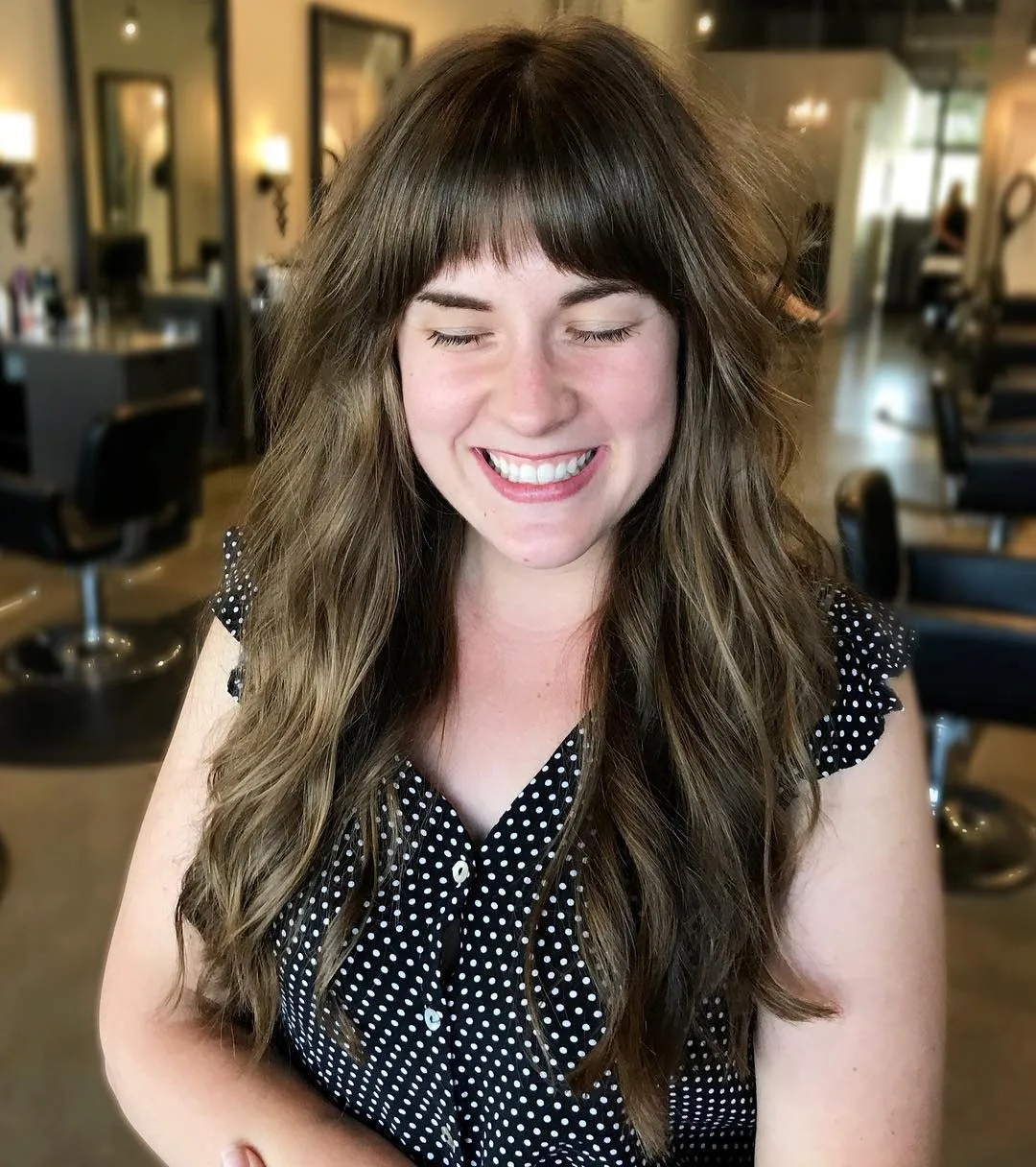 6. Warm Brunette Layers with Full Fringe (Long Textured Layers)