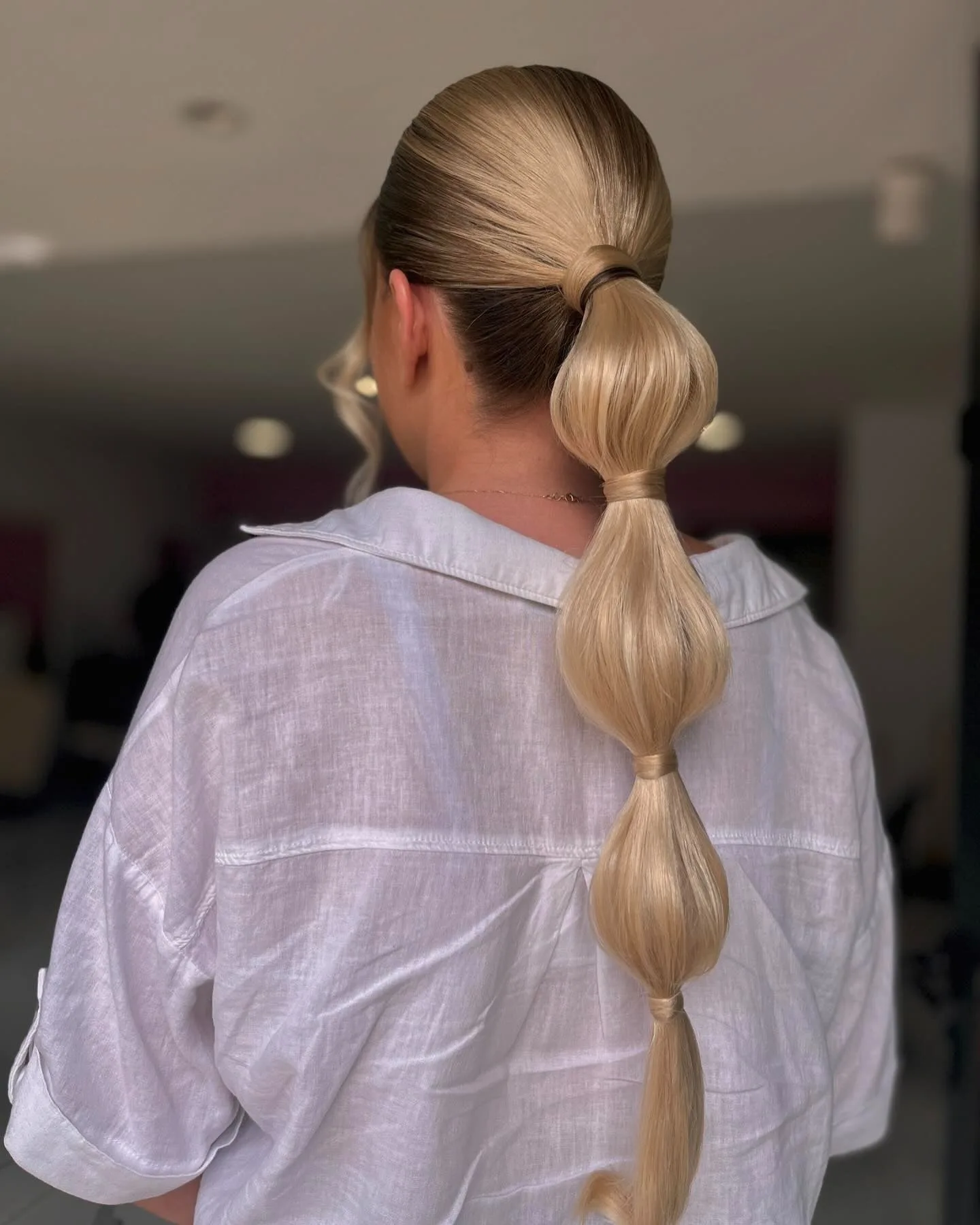 7. Glossy Platinum Bubble Ponytail with Smooth Definition (Bubble Ponytail Hairstyles)