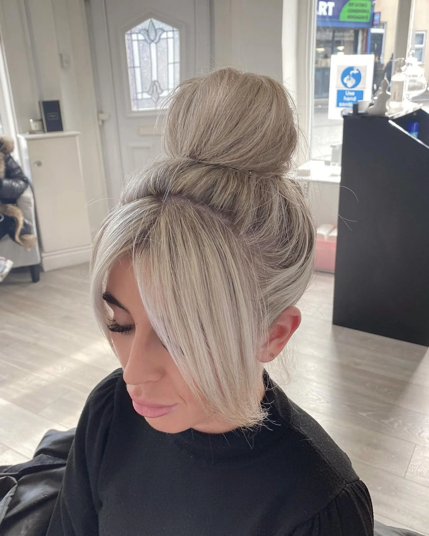 7. Platinum Sleek Top Knot with Curtain Fringe (Top Knot Hairstyles)
