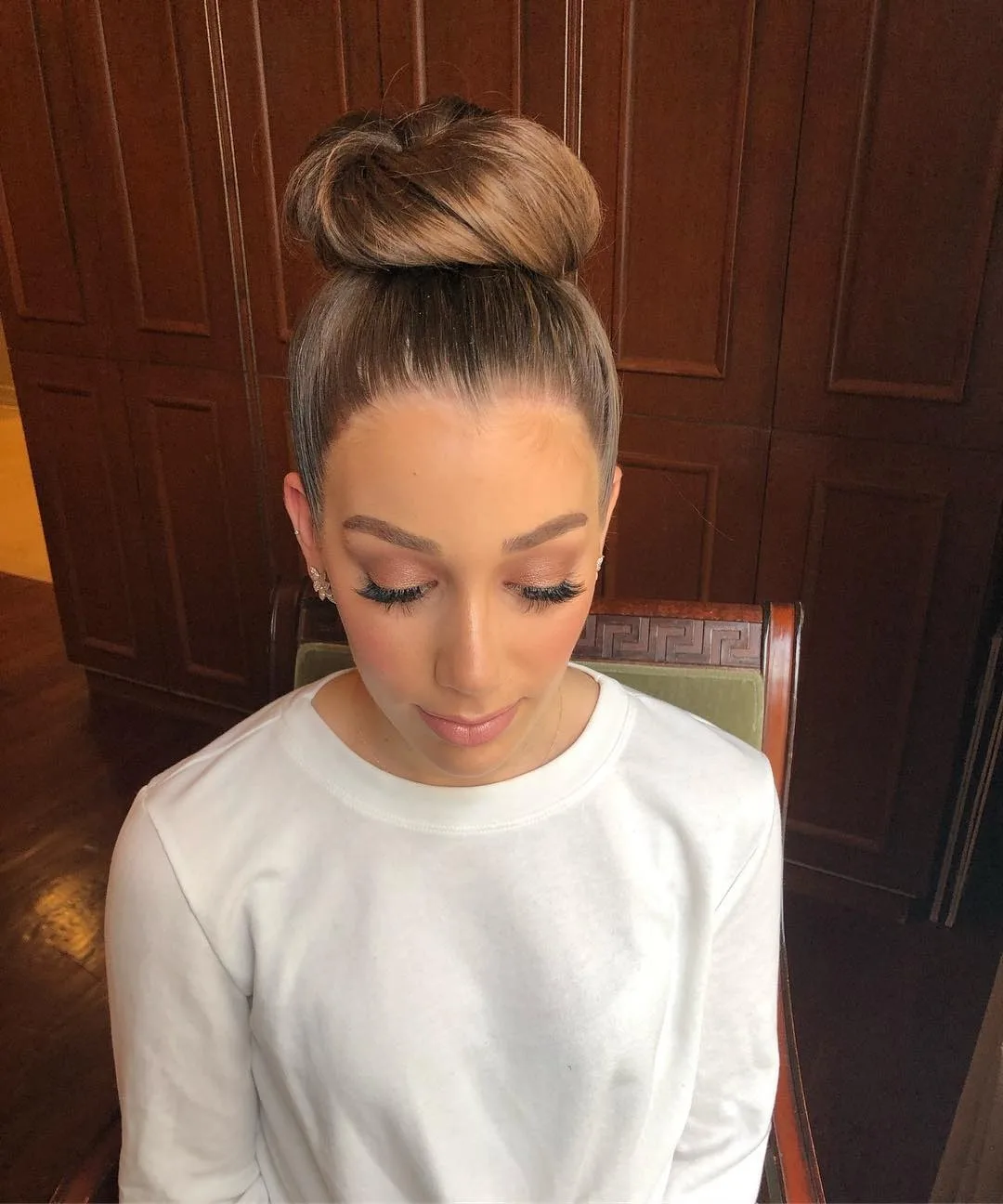 8. Polished Brunette High Bun with Smooth Finish (Top Knot Hairstyles)