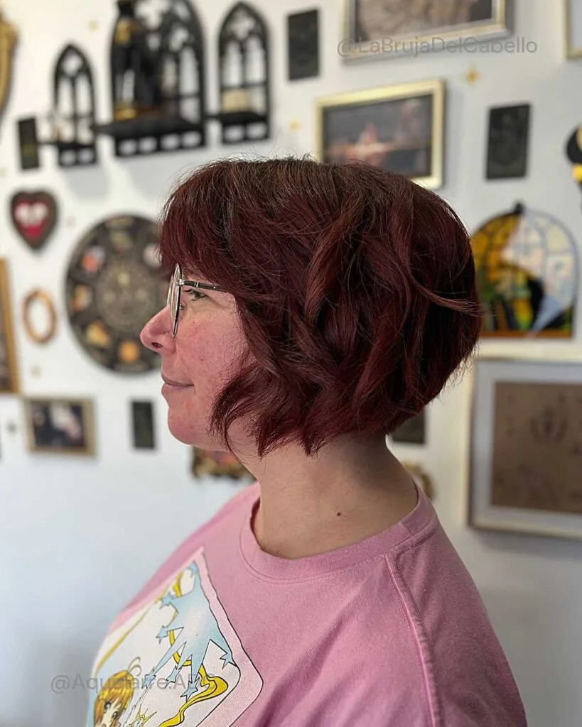 Burgundy wavy bixie with bangs and rounded bob shape
