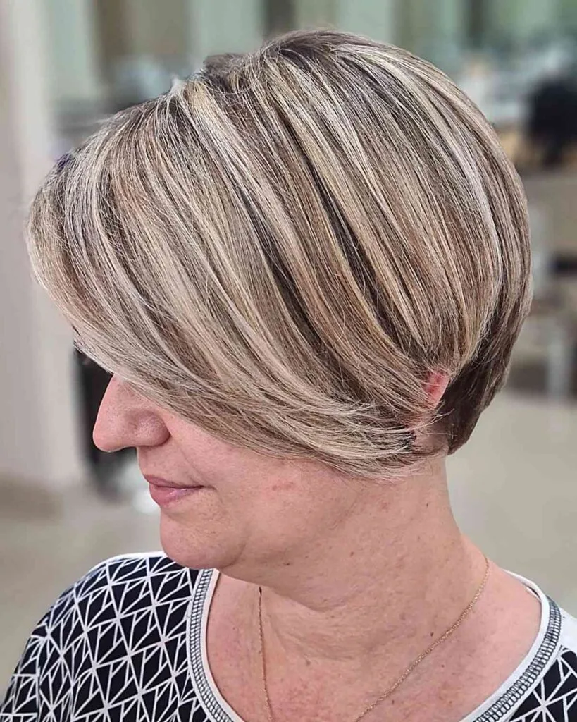 Cheek-Length Textured Short Pixie Bob with Golden Highlights on Mature Women