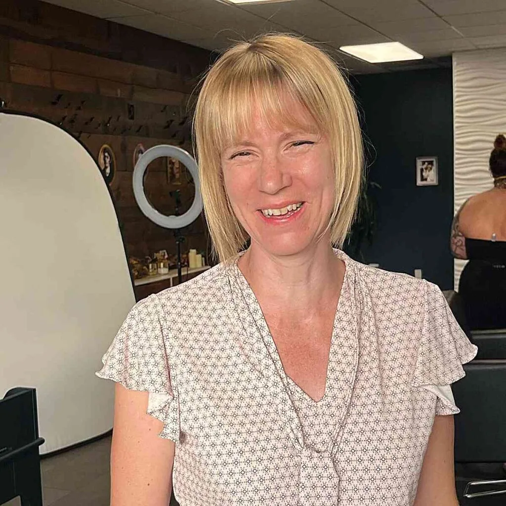 Chic Blunt Bob with Subtle Bangs for Fine-Haired Women Over 50 with Long Face Shapes