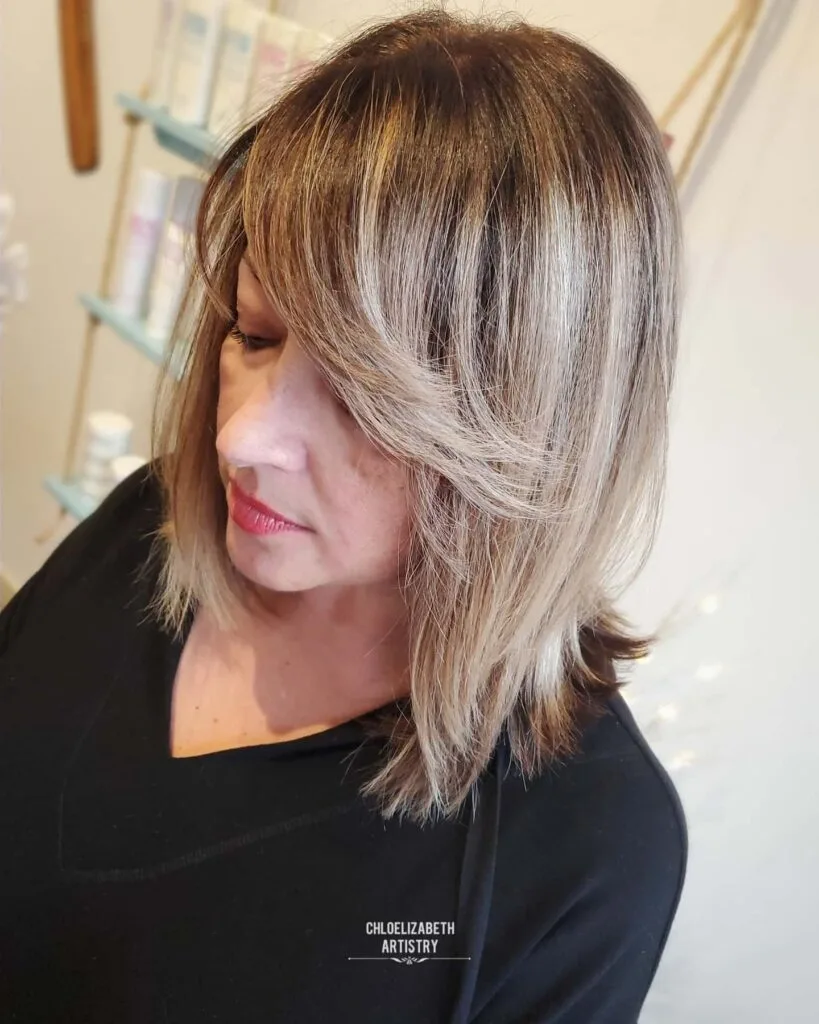 Chic Layered Cut with Bold Side-Swept Bangs