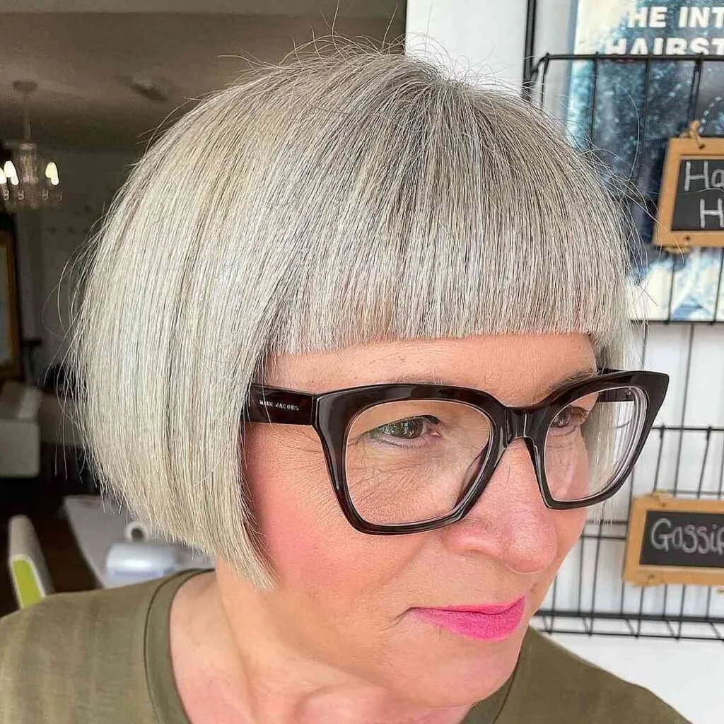Chic Salt and Pepper French Bob with Straight-Across Bangs for Ladies Over 60 with Glasses