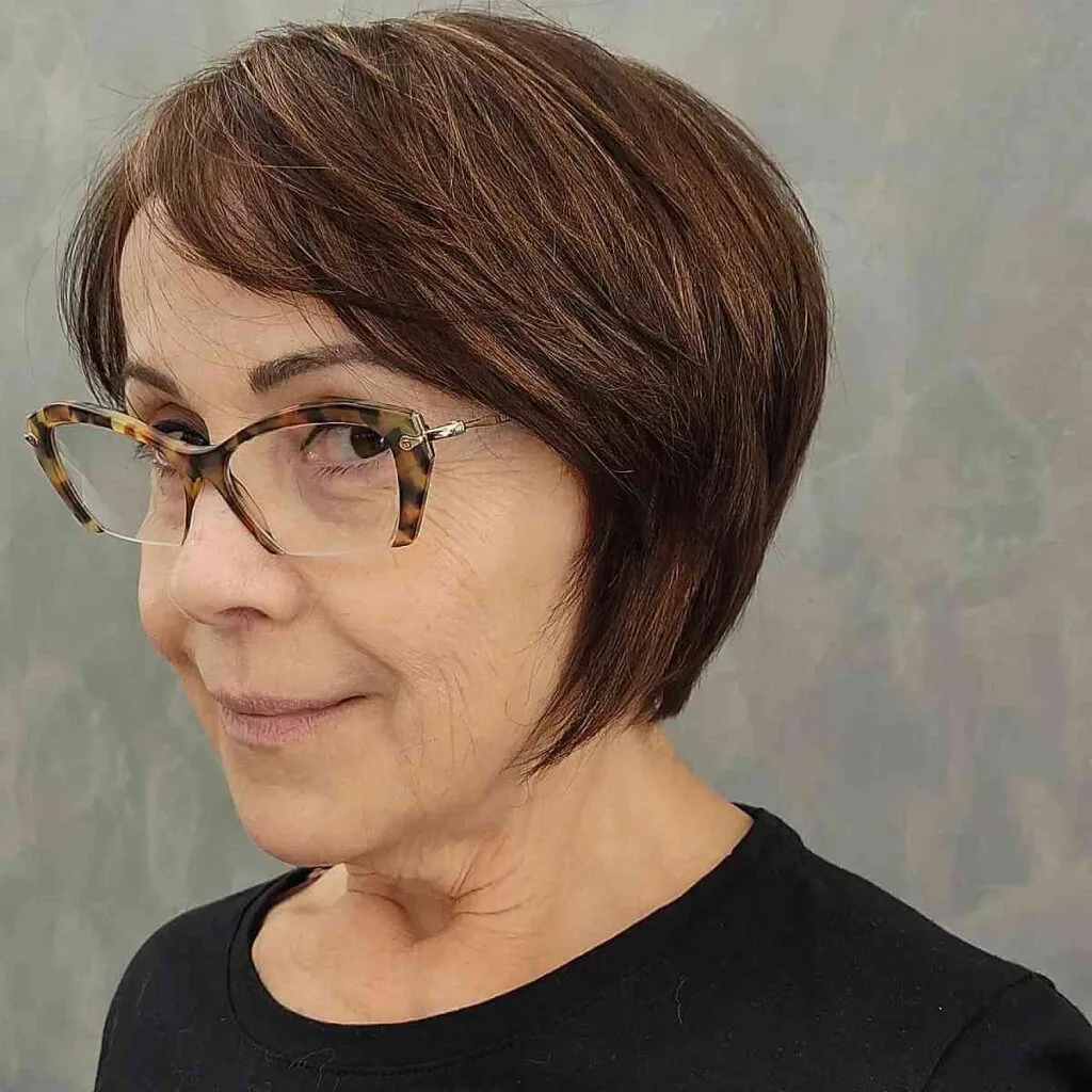 Chic Side-Swept Bob Hairstyle for a 60-Year-Old with Glasses