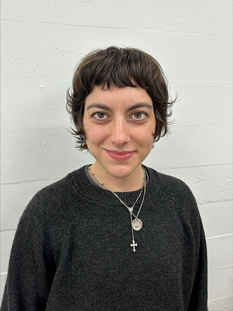 Choppy tousled brunette bixie with short wavy bangs