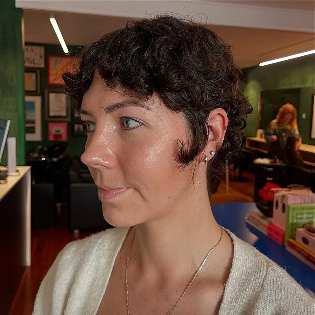Dark curly bixie with tight ringlets and short sides