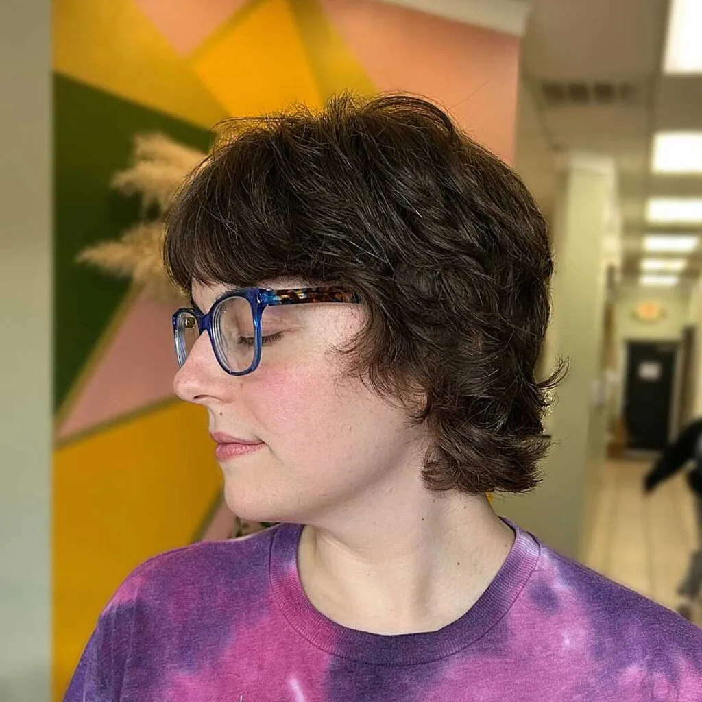 Dark wavy bixie with bangs and soft shaggy layers