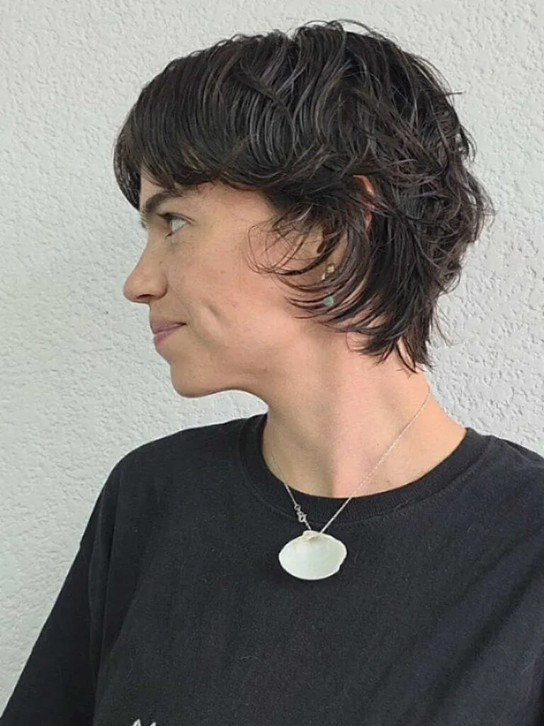 Dark wavy bixie with micro bangs and shaggy layers