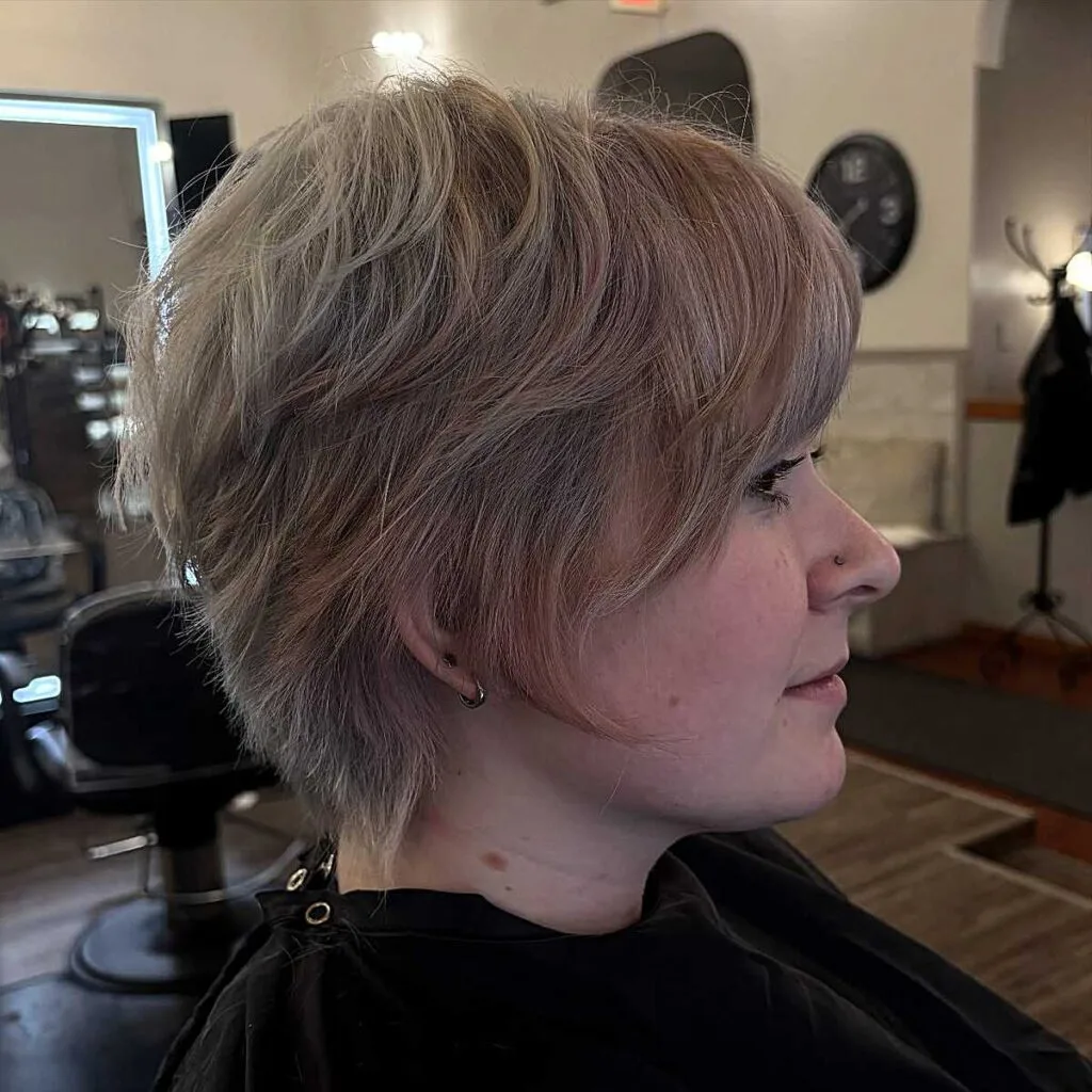 Dusty rose and ash blonde shaggy layered bixie side view