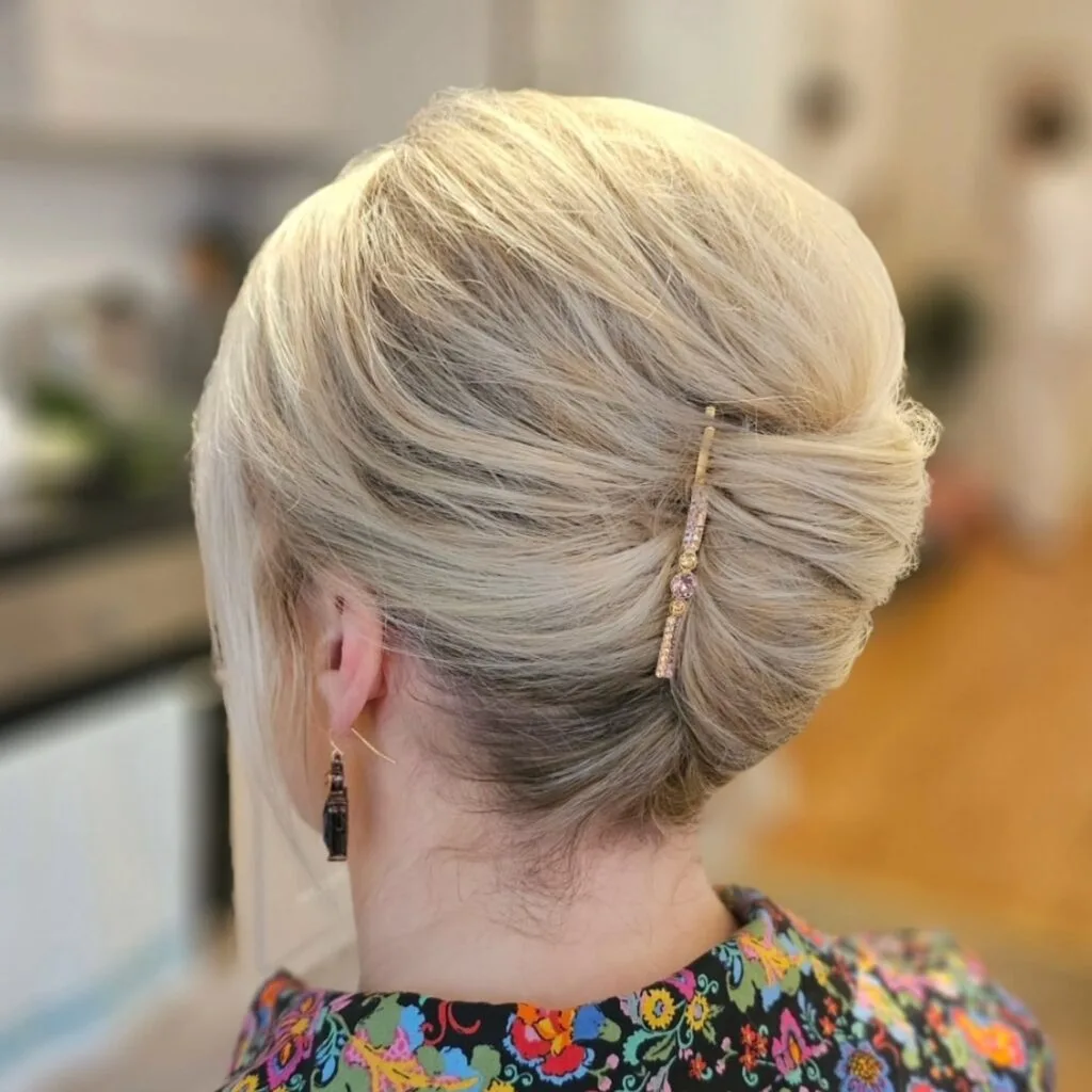 Elegant Twisted Low Bun with Decorative Pin