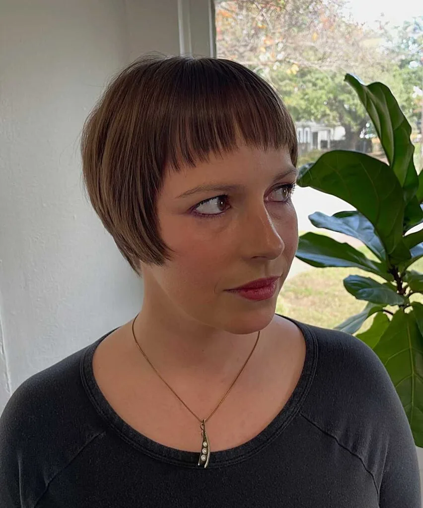Light brown blunt bixie with straight bangs and round shape