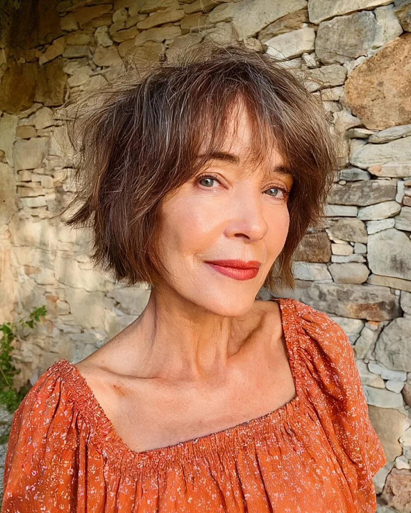 Messy choppy bob for fine flat hair on older woman with feathered layers and tousled texture