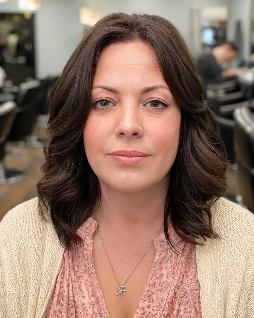 Middle-part brunette lob with soft ends and layered texture for women over 40 with round faces