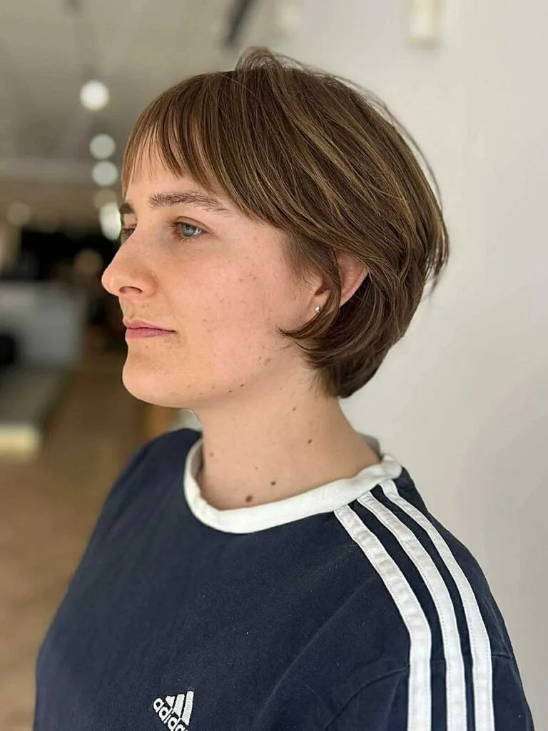 Sandy blonde layered bixie with wispy bangs and texture