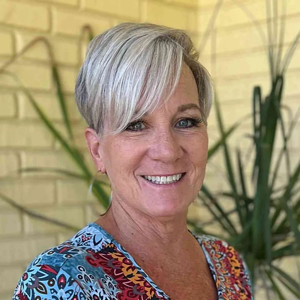 Short Bold Pixie Cut Featuring a Frosted Hue for Ladies Aged 50 with sweeping bangs