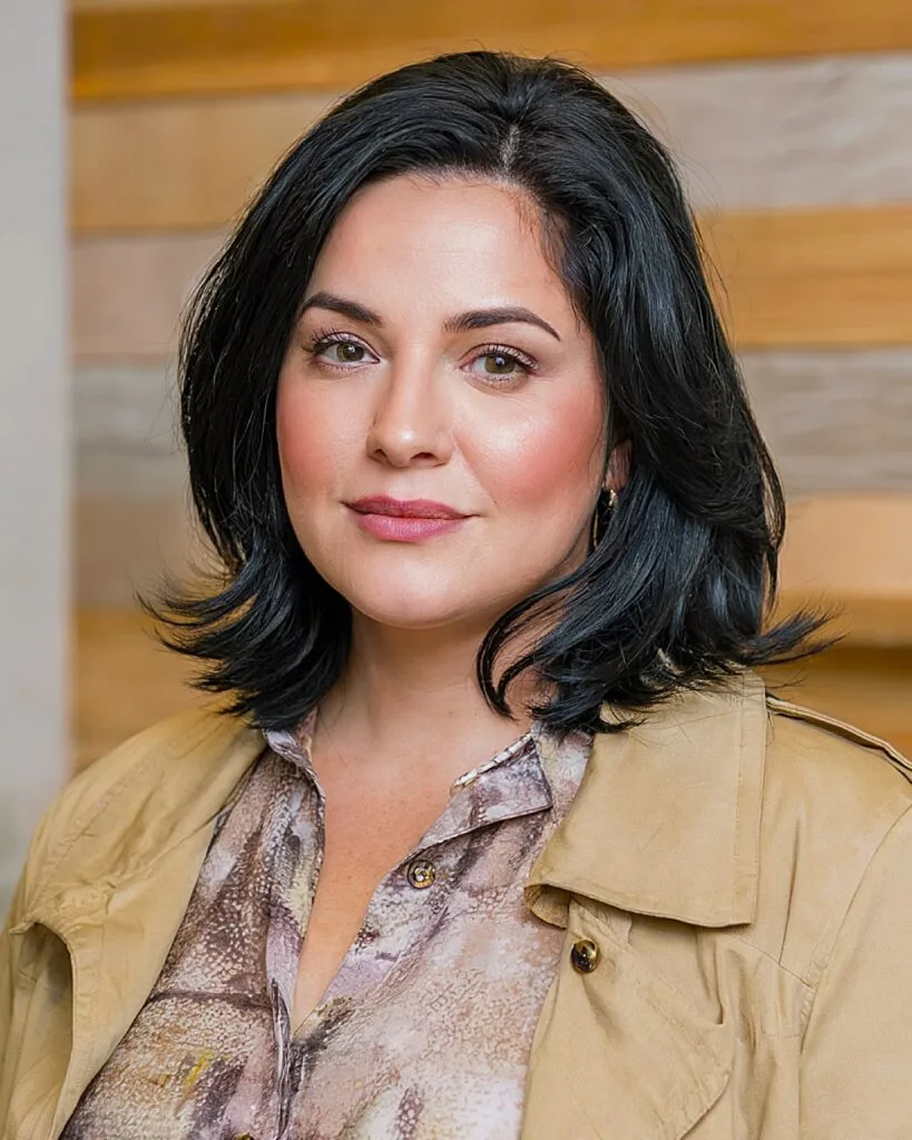 Shoulder-length black lob with feathered ends and subtle layers for women over 40 with round faces