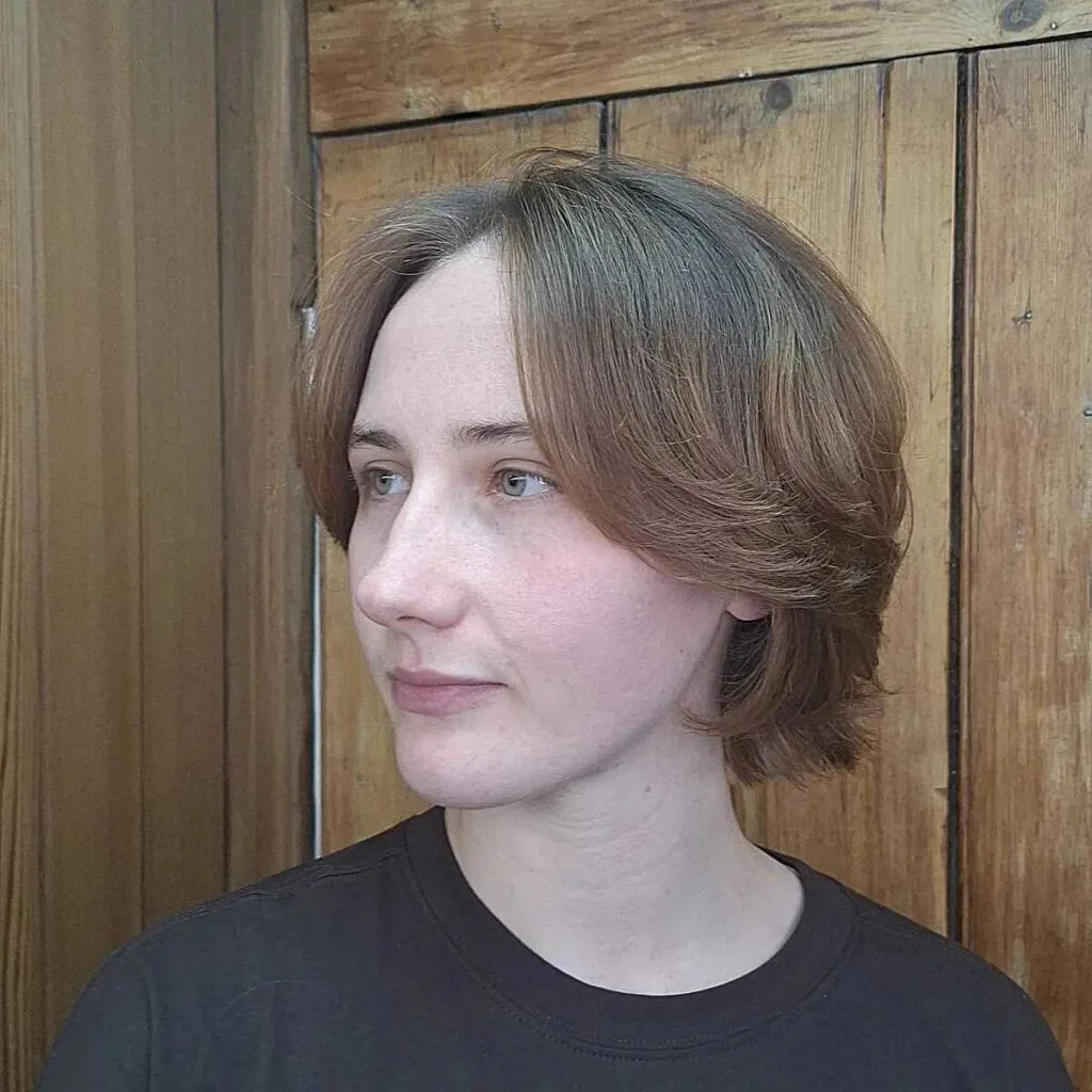 Soft auburn bixie with side-swept layers and flipped ends
