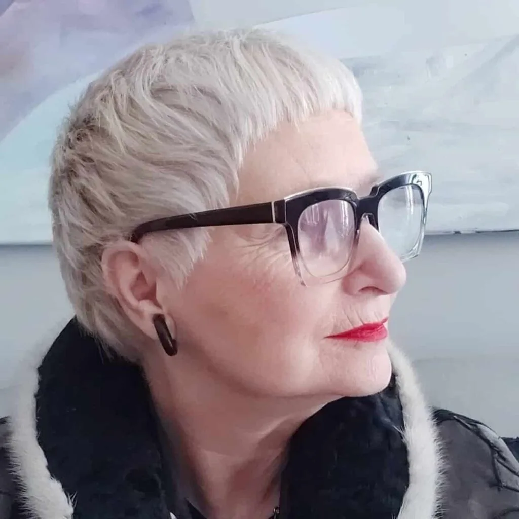 stylish short crop with bangs for women over 60 with round faces