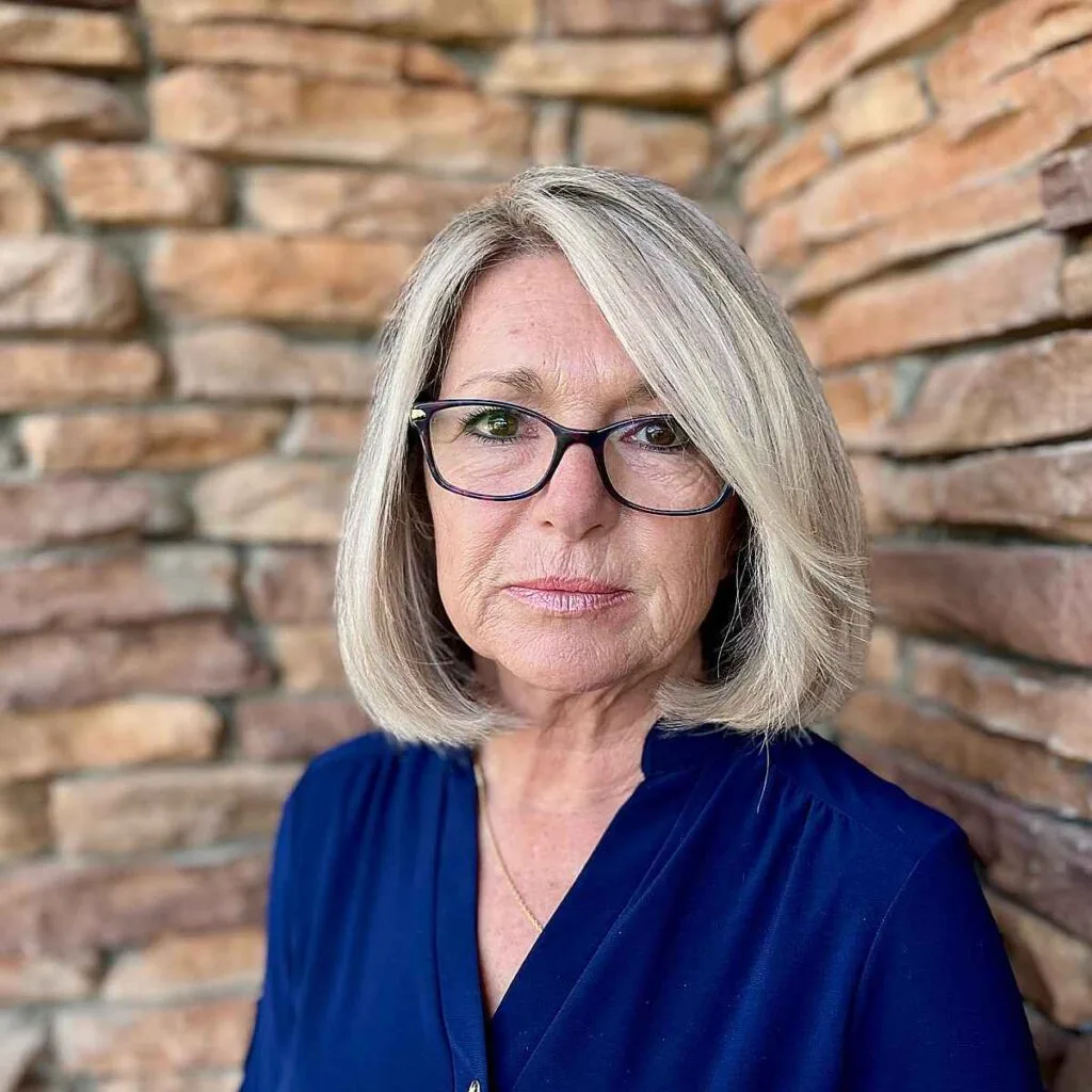 textured bob hairstyle for older adults with glasses