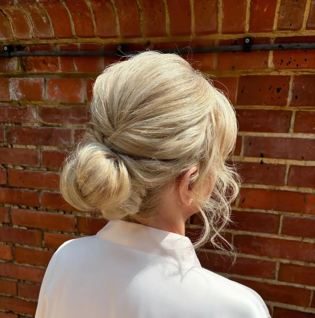 Textured Low Chignon with Soft Face-Framing Tendrils