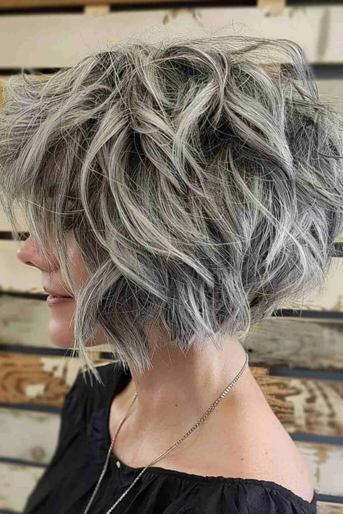 Textured tousled ash gray bob hairstyle for mature women highlighting contemporary styling and natural gray integration
