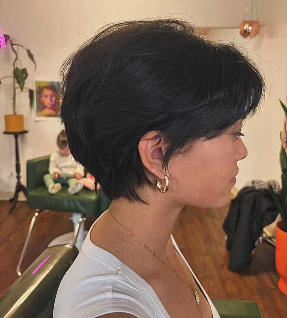 Voluminous jet black bixie with textured layers side view