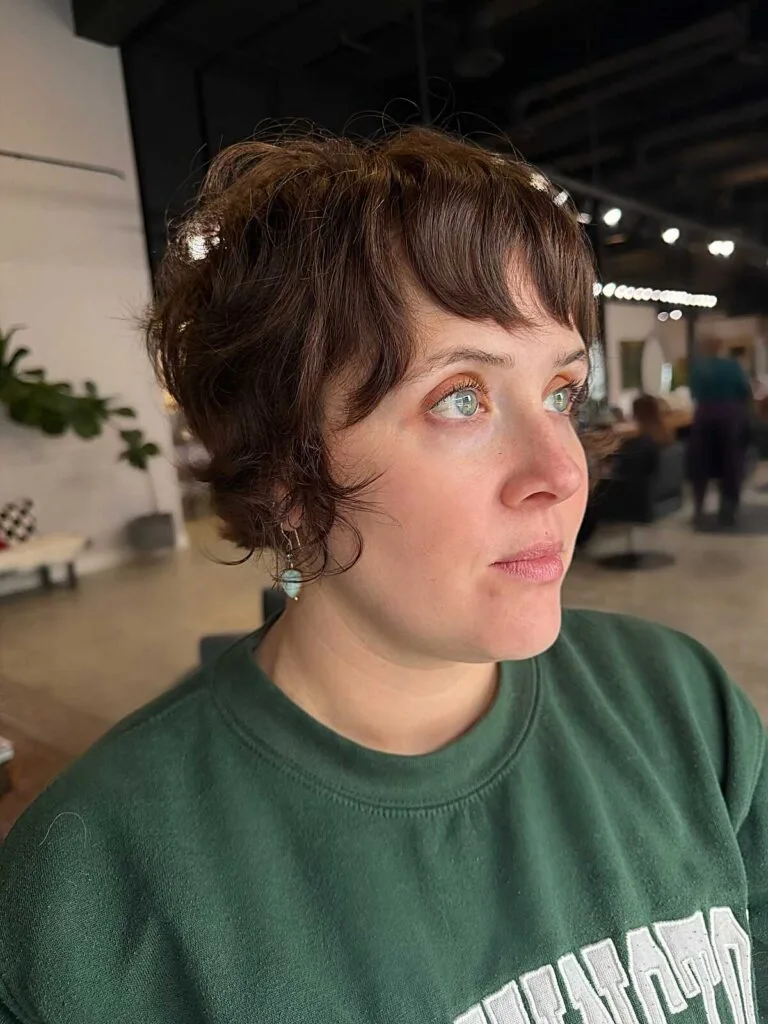 Wavy brown bixie with soft curtain bangs and volume