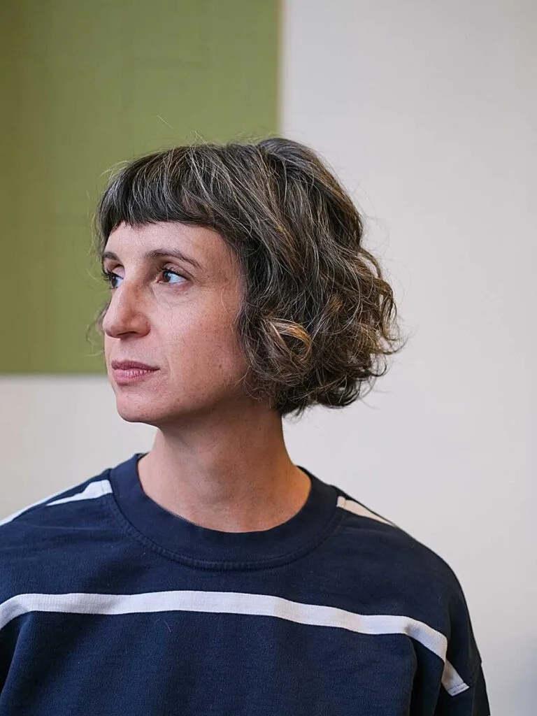 Wavy brown chin-length bob with short micro bangs