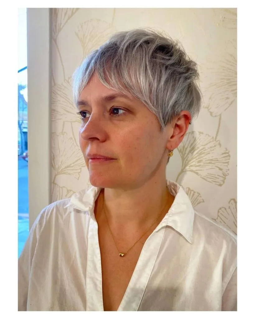Charming Choppy gray pixie cut with long bangs for women over 50