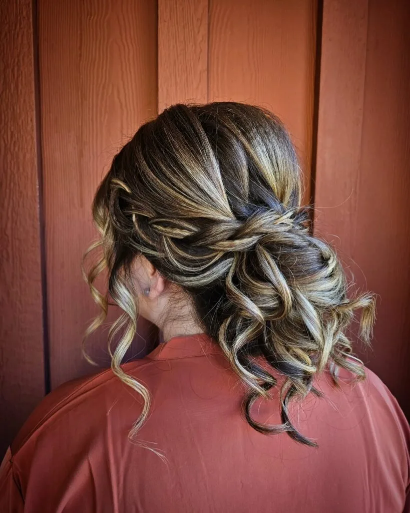 Chic Braided Updo with Soft Curls and Highlights