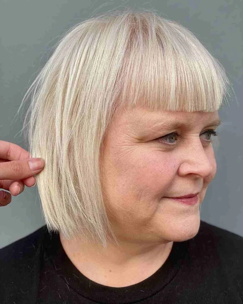 Chic Woman in her fifties showcasing a Short Blunt Cut with Striking Blunt Bangs