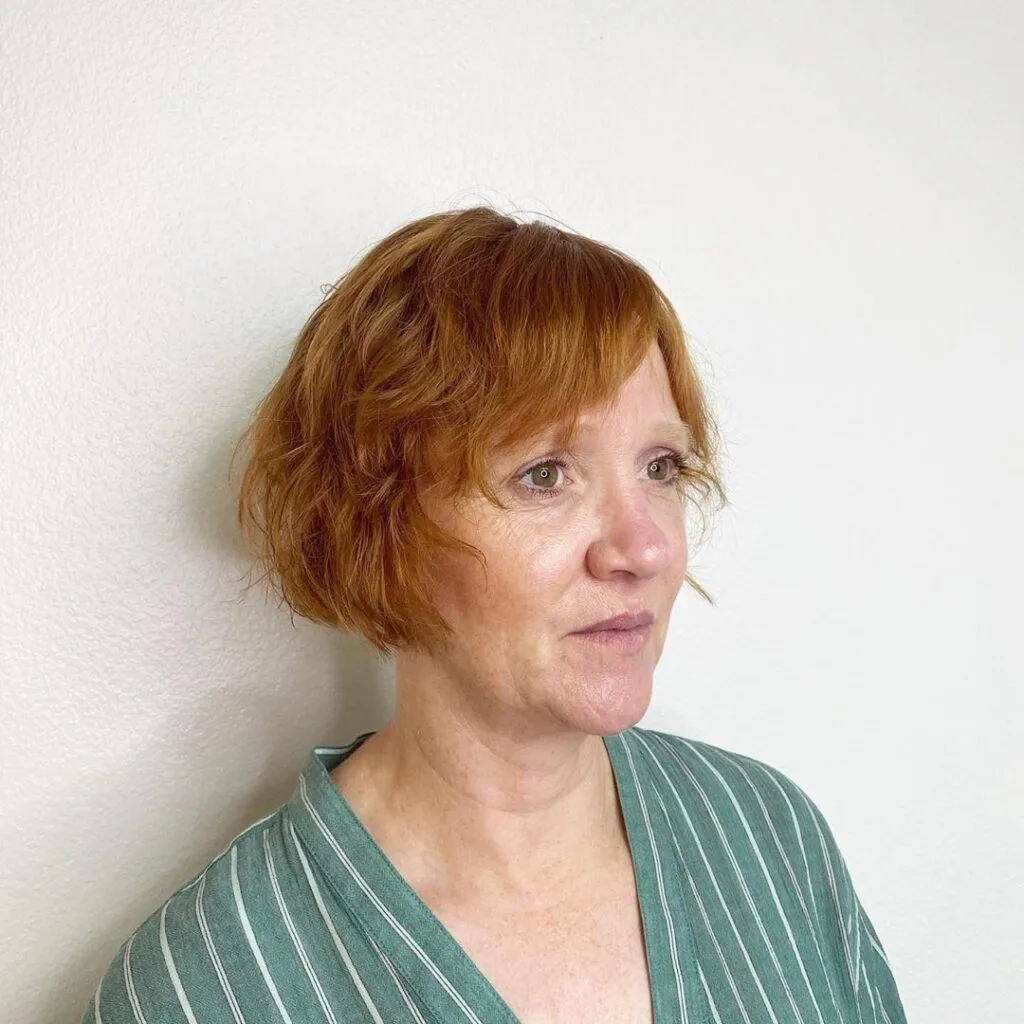Ear-Length Textured Bob with Bangs for Wavy Hair suitable for women over 50