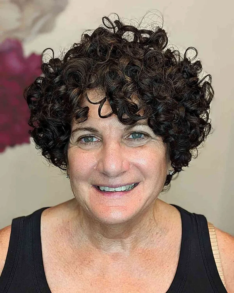 Elegantly Structured Curly Bob with Bangs for Women Aged 50