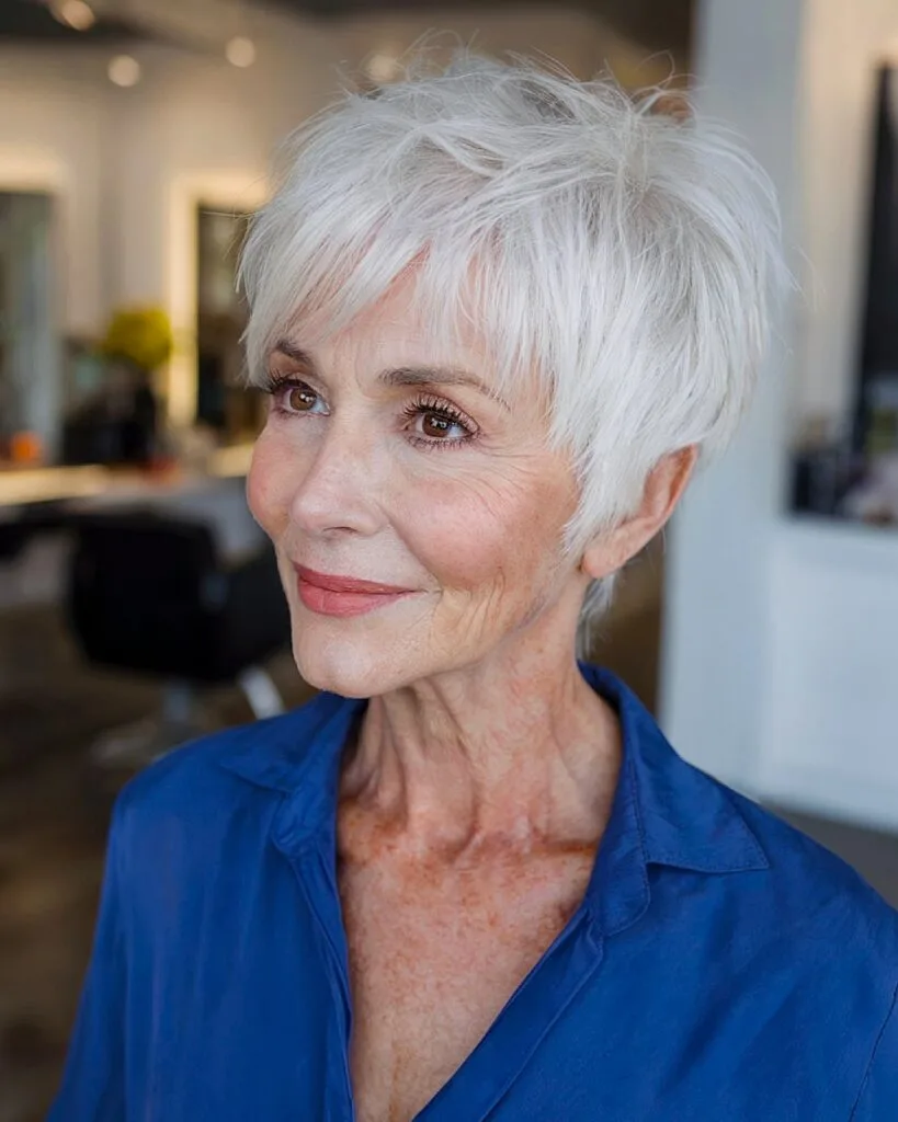 Feathered silver pixie shag haircut for women over 70 with wispy bangs and textured crown