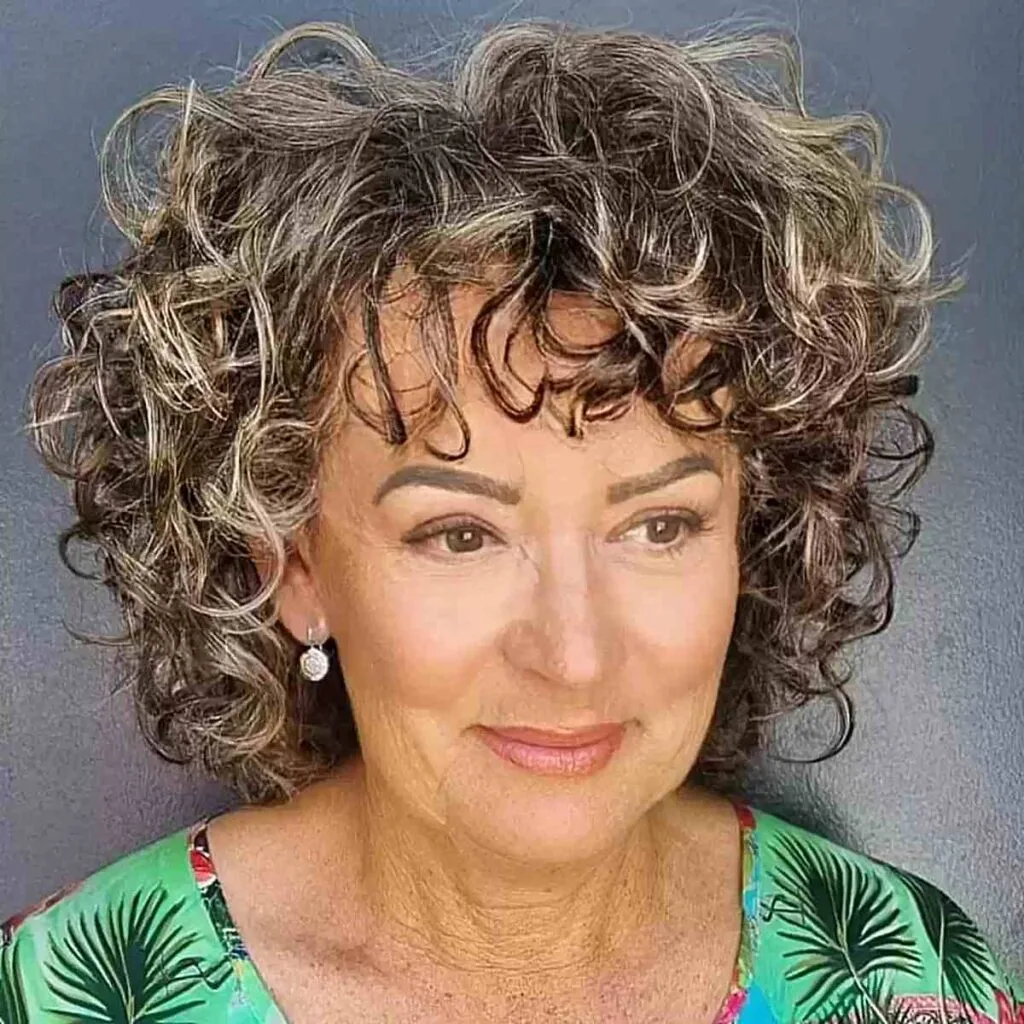 Medium-Length Curly Bob with Textured Bangs on Women Aged 50