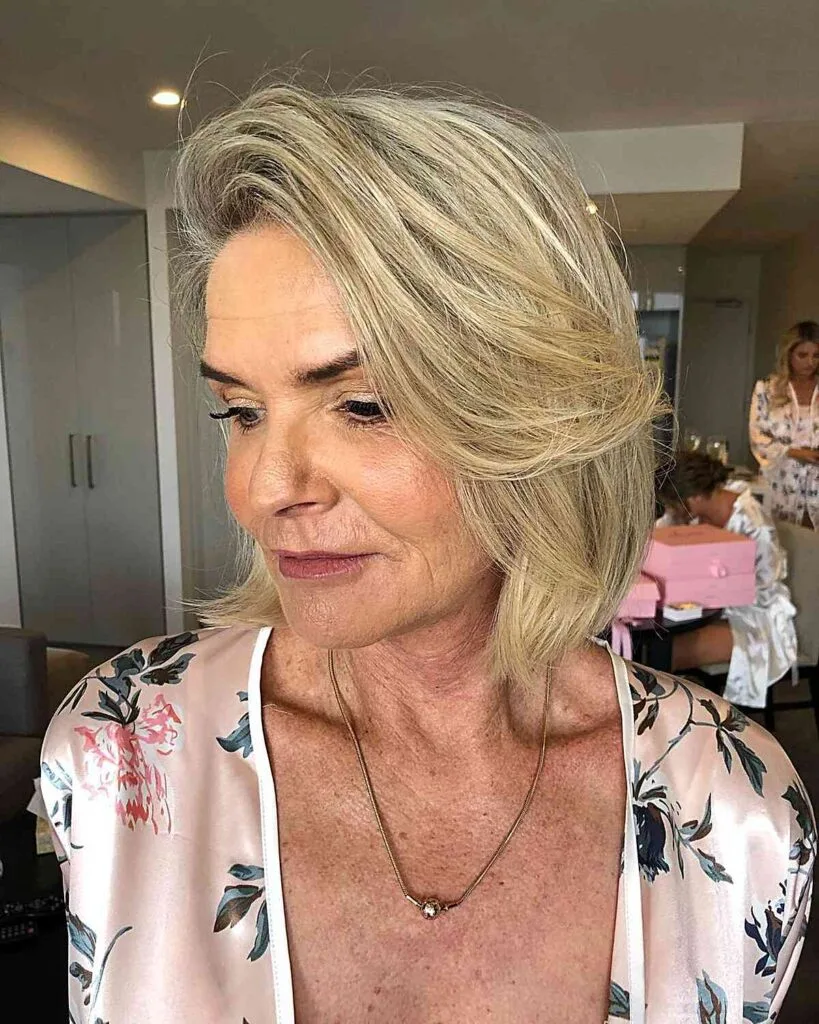 Neck-Length Blonde Lob with a Deep Side Partition for Fine-Haired Women in their 50s