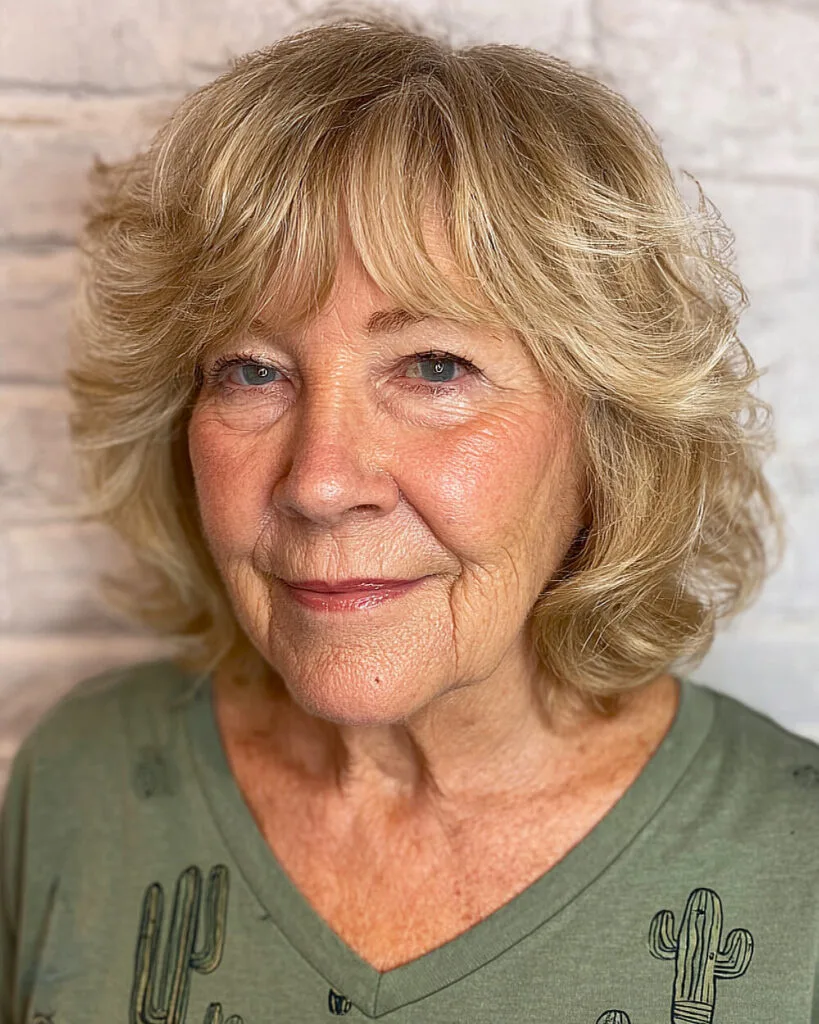 Neck-length textured shag with curtain bangs for women over 70