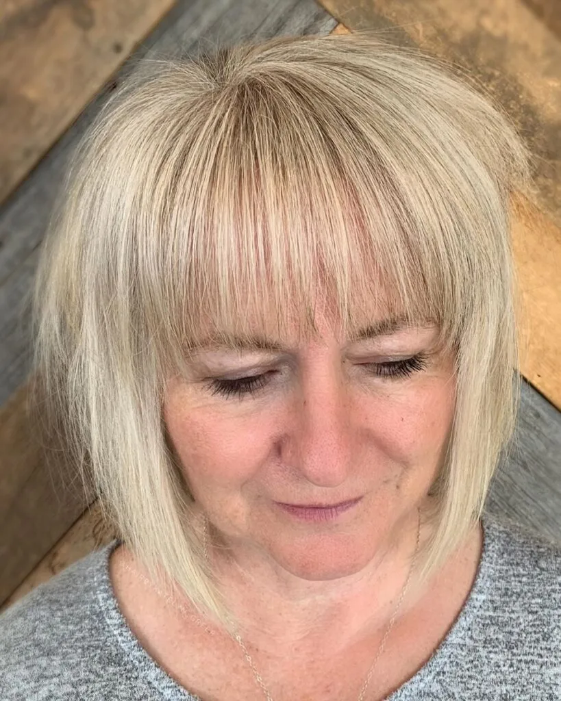 Short to Medium Haircut Featuring Bangs for Women Aged 50 and Above