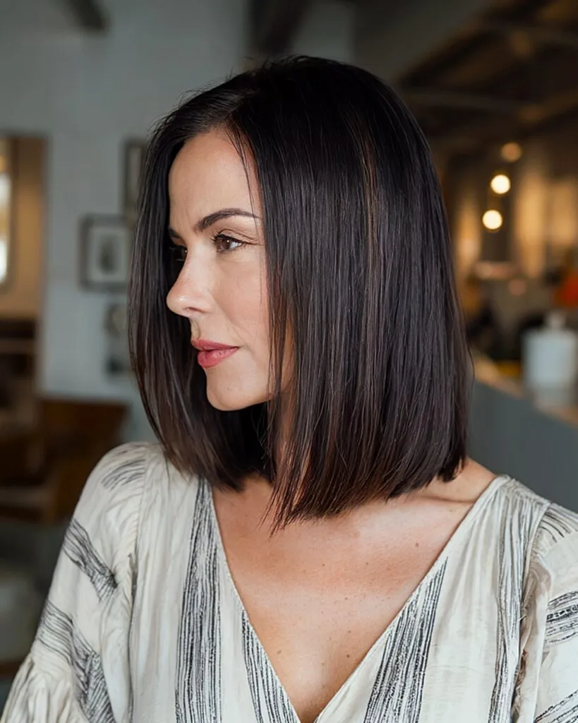 Sleek blunt cut for medium-length hair over 40 with a sharp collarbone-length finish